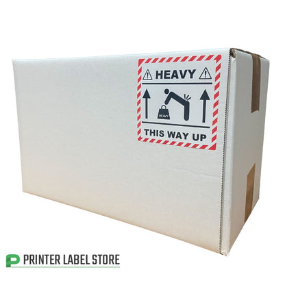 Cardboard box with a 'Heavy This Way Up' label - 100 x 100mm - printed red & black